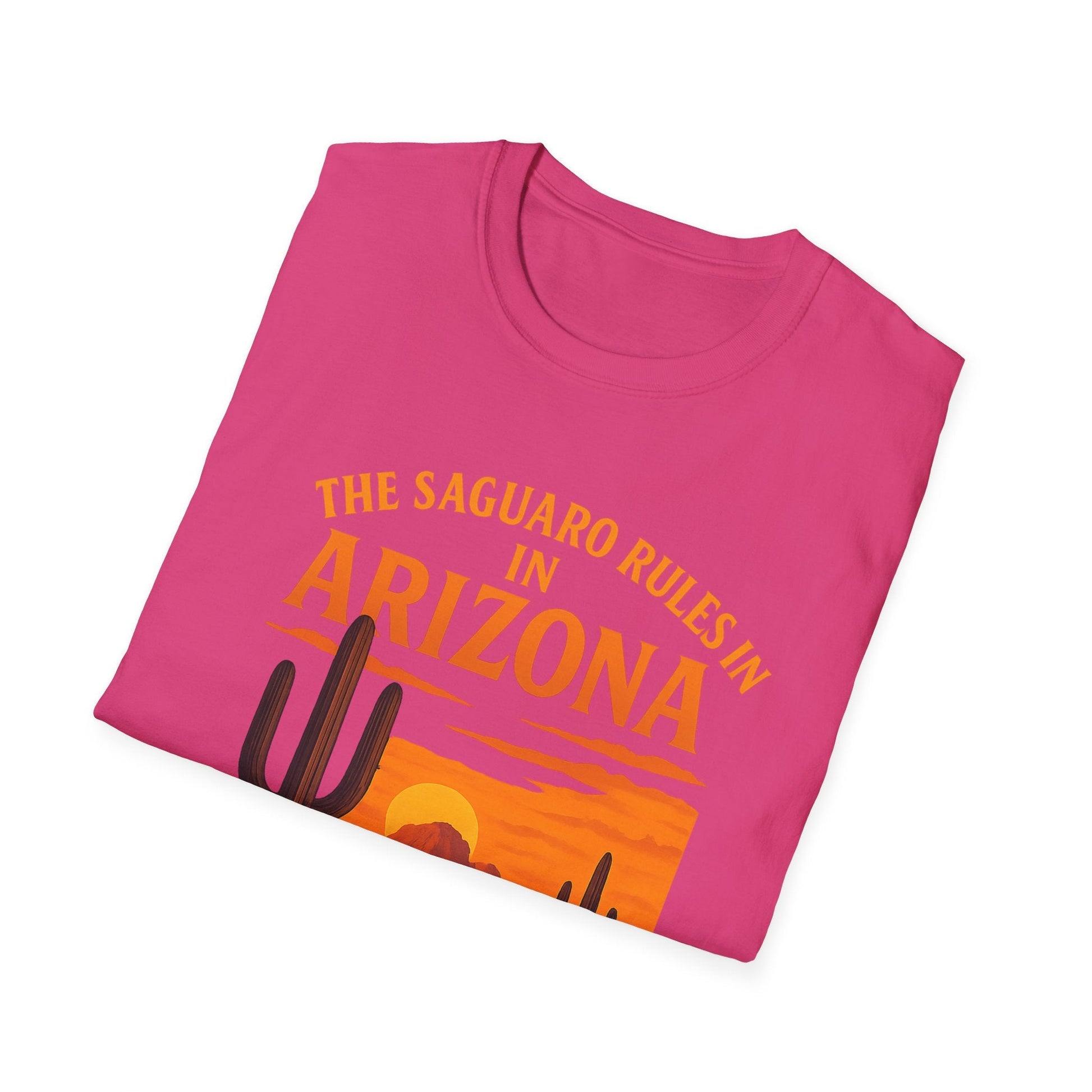 Folded pink t-shirt with 'The Saguaro Rules in Arizona' design, featuring cacti and a sunset.