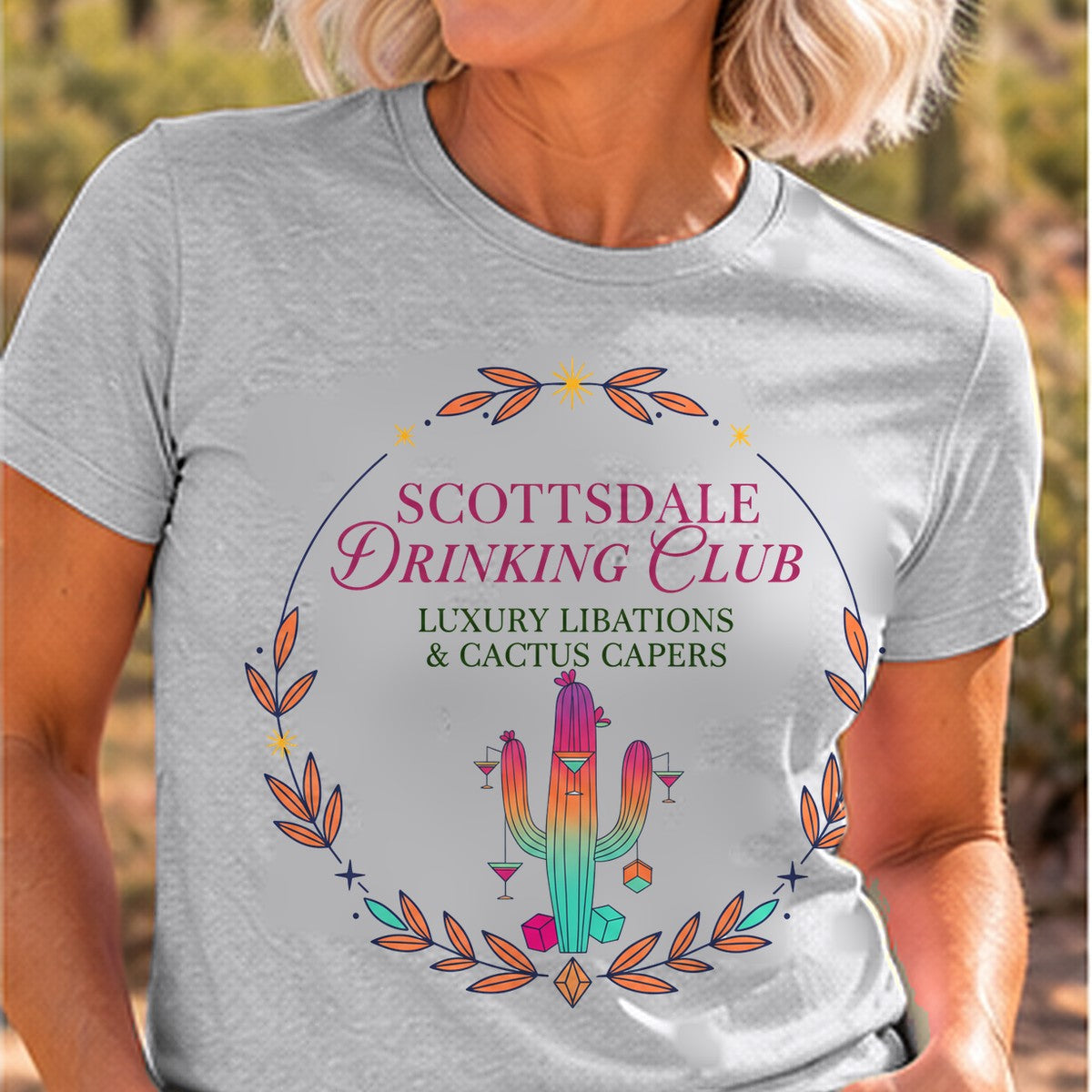 Scottsdale Drinking Club Cocktail Arizona T-shirt worn by a woman in the Arizona desert
